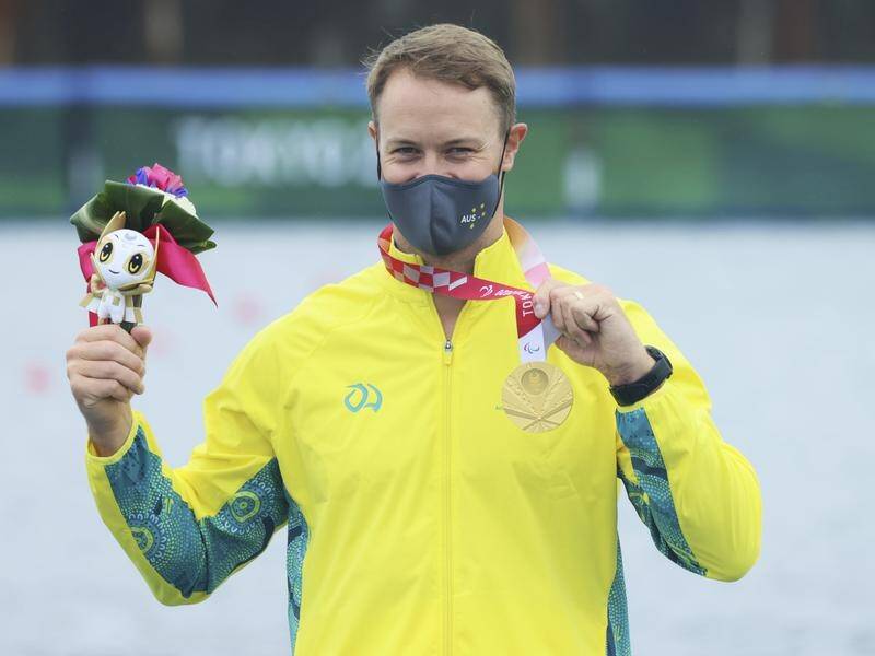 Curtis McGrath shows off his gold medal from the VL3 200m canoe sprint race at the Paralympic Games.