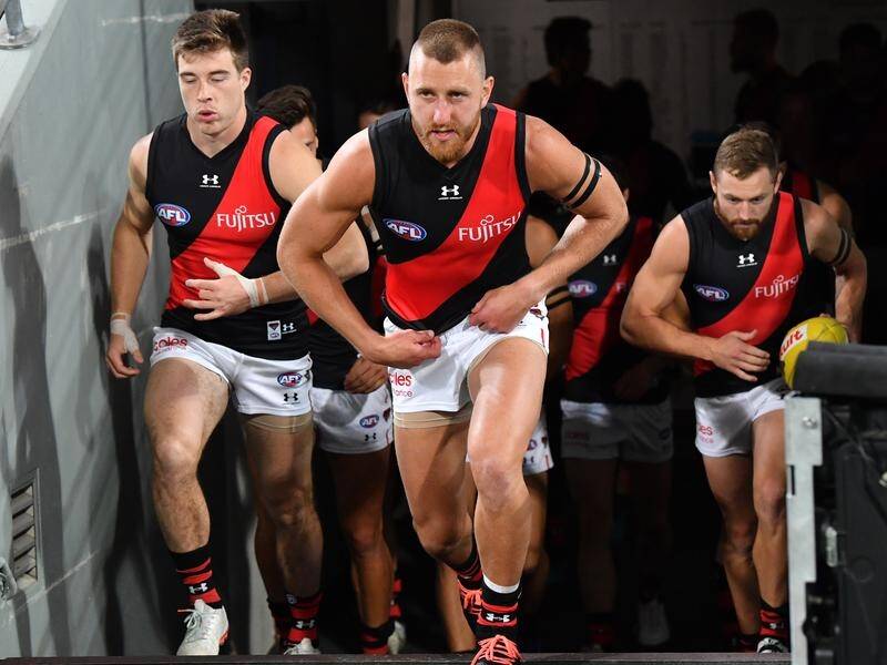 Dyson Heppell (c) will lead Essendon for a fifth consecutive season in the AFL.