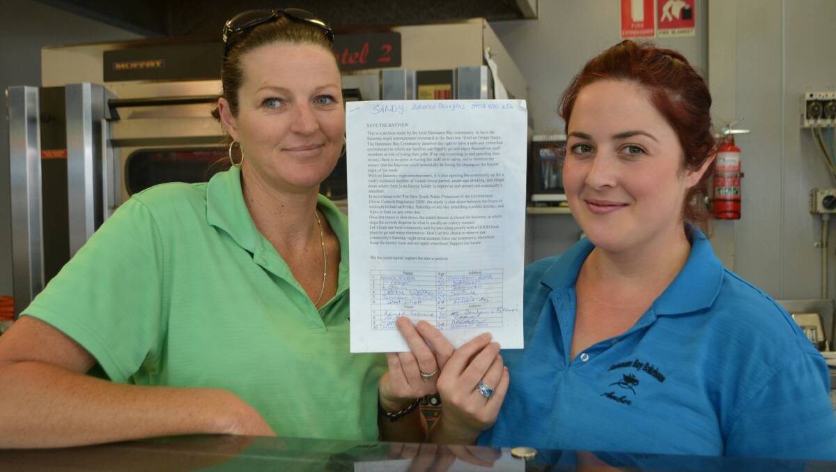 PEOPLE POWER: Batemans Bay Bakehouse staff Sandy Rourke and Amber Pickett with the petition to return live music to the Bayview Hotel on Saturday nights.