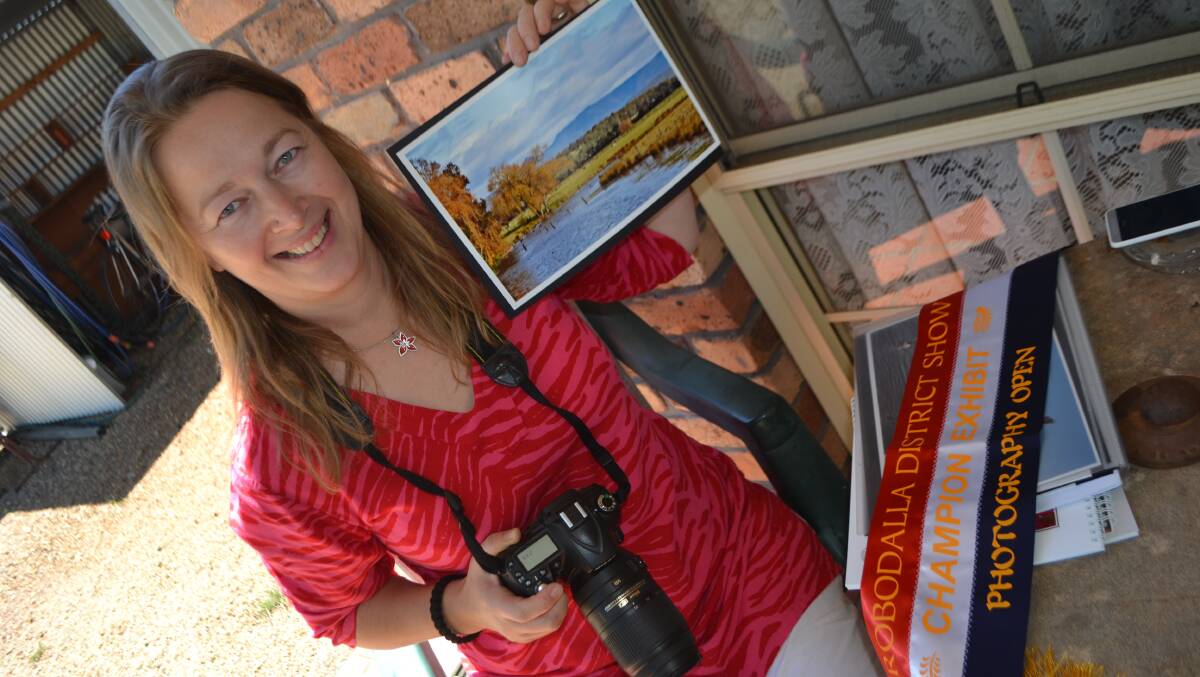 HAPPY SNAPPER: Moruya photographer Lisbeth Westra with one of her photos of Mullenderee Creek and one of the prizes she has won at the Eurobodalla Show.