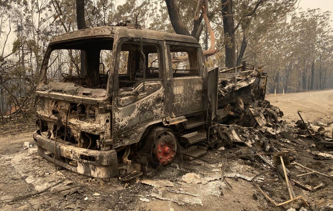 One of the two burnt out trucks of Strike Team Golf after their convoy was overrun by flames on Hames Road, Nowra Hill. Photo: Stuart Thomson.