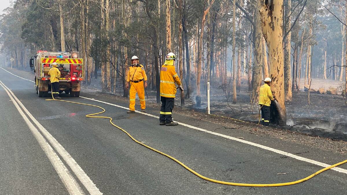 A West Nowra RFS crew mopping up and blacking out along Forest Road at 6:30pm just as conditions were starting to ease. 