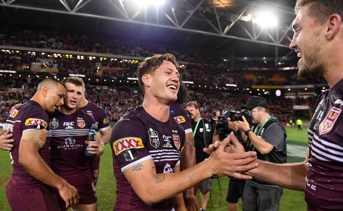 Grinners: Kalyn Ponga of the Maroons (centre) celebrates with Corey Oates following Game 1 of the 2019 State of Origin series. AAP Image/Dave Hunt.