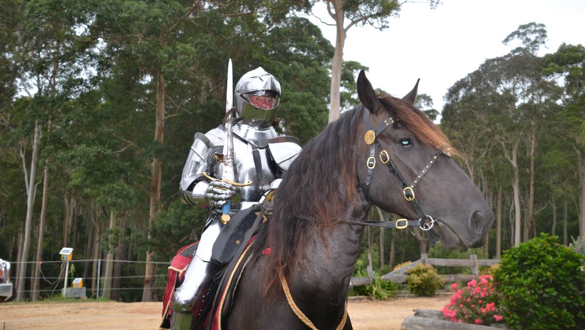 KNIGHT IN SHINING ARMOUR: Darrell Bossley on his Friesian horse S'Calibur. Bossley is wearing a full set of reproduction 15th-century steel armour.