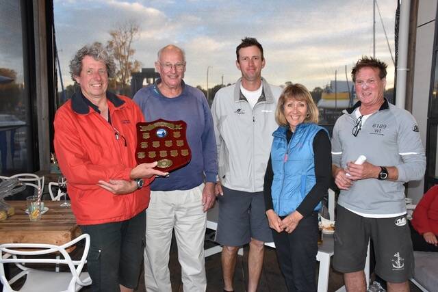 GRINNERS: The winning crew of Xanthia, skippered by James Gardiner (second from left), with their trophy.