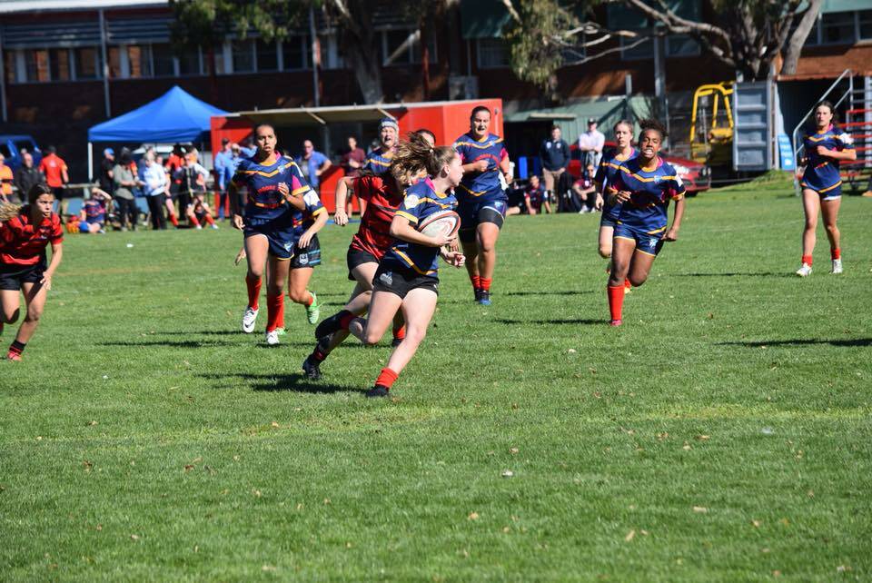 WARRIOR: Eleni Ives, who attended Narooma High School, runs the ball while playing for the Far South Coast Falcons.