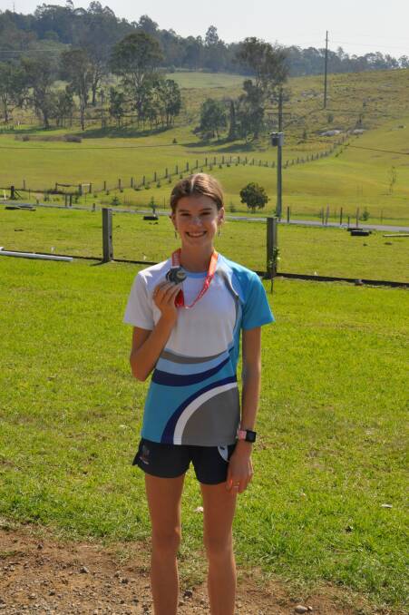 Shayne Hargraves shows off the silver medal she won in the under 17s 3000-metre race at the Australian Championships in Sydney.