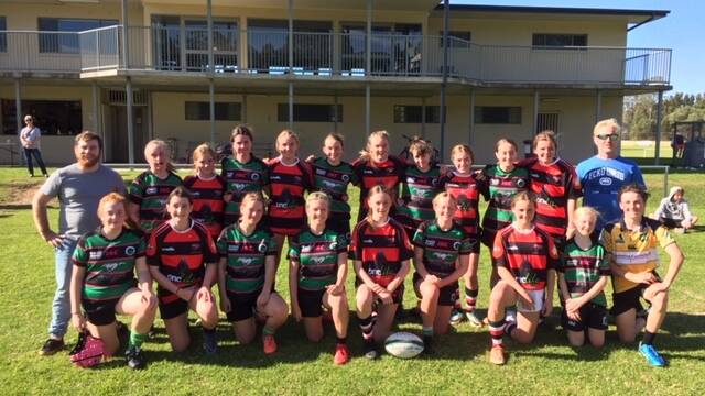 The Batemans Bay Boars under 14s girls' team with the Jindabyne side after a recent home game.