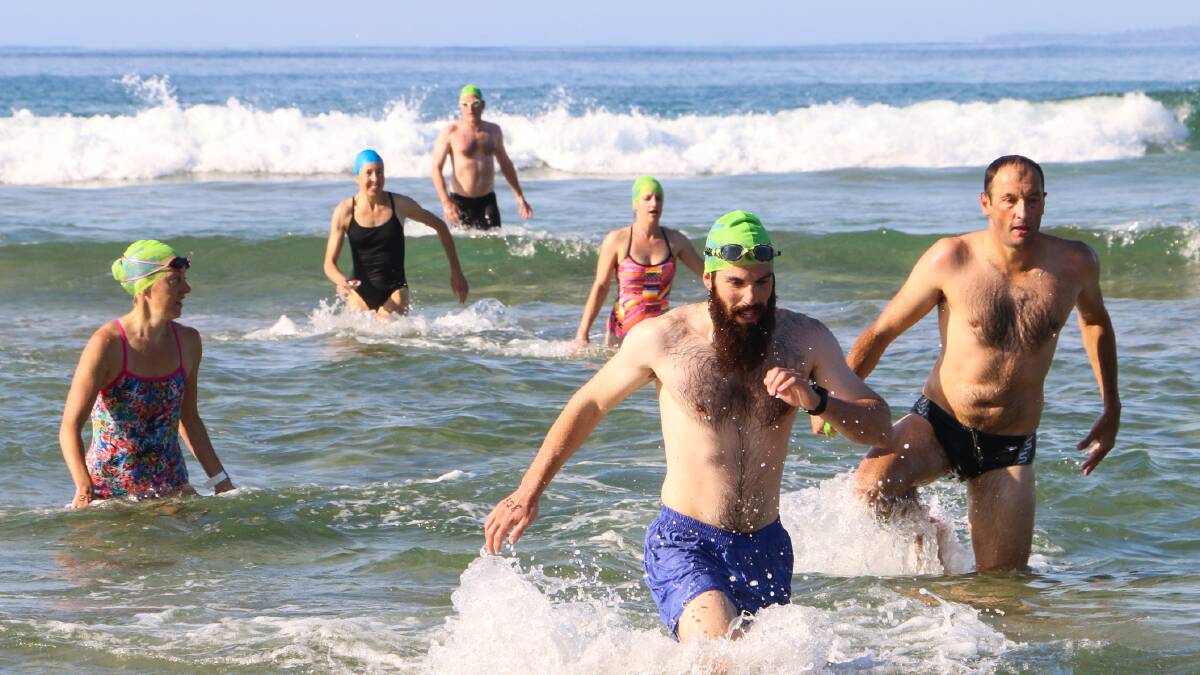 Competitors return to South Broulee Beach after the 1.4-kilometre Bay to Breakers Ocean Swim. Photo: John Hicks.