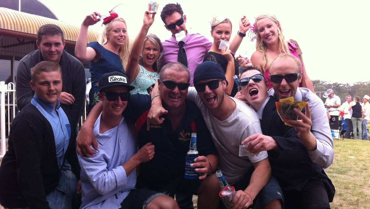 LUNAR LOVERS: Harold Wilson, Chris Peters, Mitch Pearson, Matt O’Neill, Richard Sellick, Aimee Bergan, Nicole Cuthbertson, Gary Dunn, Anna Morrissey, Sania Forsythe, Jack Saunders, and Mike Hawley celebrate at the Moruya Racecourse after their pick, Green Moon, came home in the Melbourne Cup yesterday. PHOTO: DEAN BENSON
