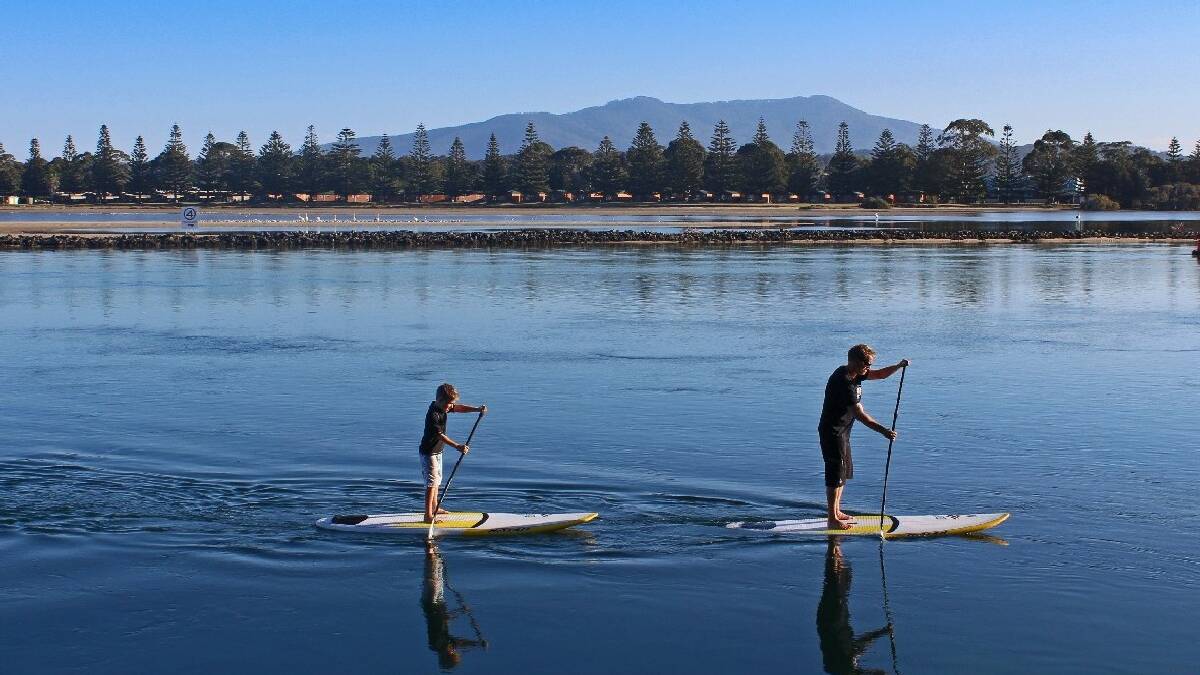  NAROOMA: Andrew “Macca” McCaughtrie has just started “South Coast Stand-up Paddleboarding” and wants to teach you to SUP. Andrew “Macca” McCaughtrie and his son   Jack, 8, SUP down the main channel at Narooma.