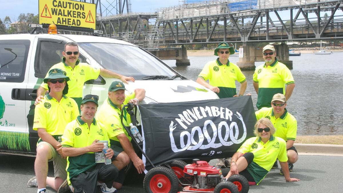 BATEMANS BAY: Tom Garney of Adelaide, Kevin Tingey of Surfside, Michael D-Elboux, Gary Black and Stephen Donlan of Canberra, Tony Hawke of Surf Beach and Karin   Semecky of Canberra are pushing a mower from Moruya to Gerringong as part of the ‘Mowathon’ to raise awareness of men’s health issues.